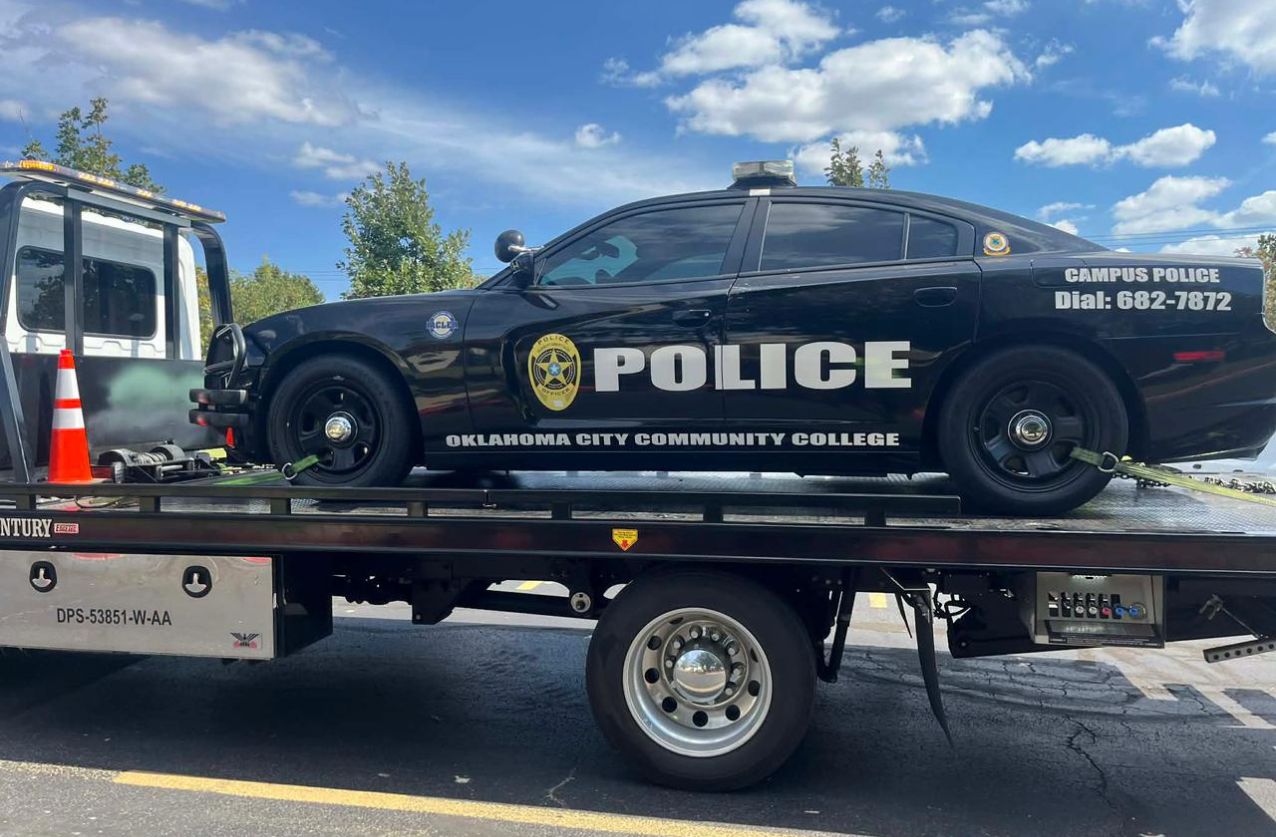 Wrecker services in Houston recovering a police car from highway with cones